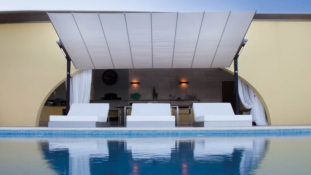 Home antilever shade umbrella without center pole over luxury pool lounge area